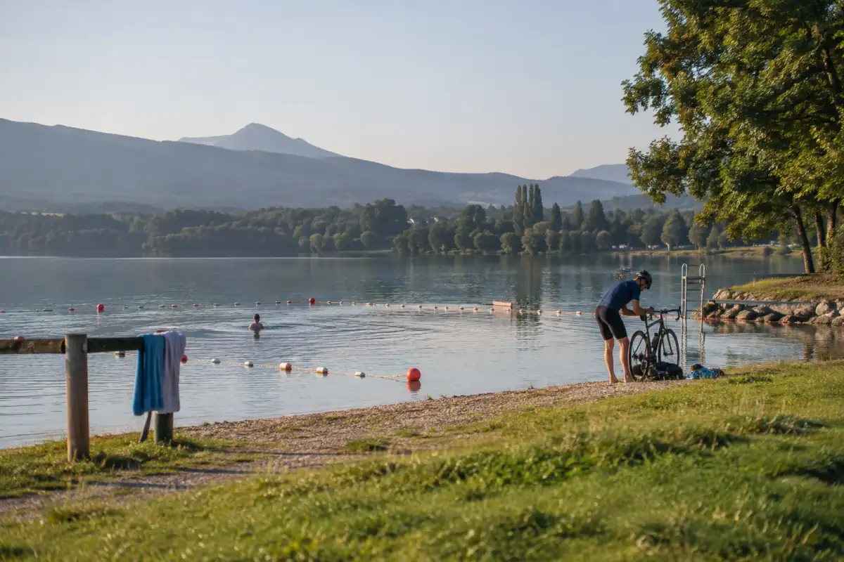 Activités sportives d’été au bord d’un lac : natation en zone de baignade et vélo sur un itinéraire proche.