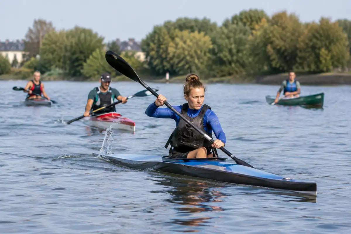 Des kayakistes et un céiste pagaient sur une rivière lors d’une course de canoë-kayak marathon.
